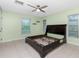 Light filled main bedroom offering tile flooring and a ceiling fan at 1190 Victoria Ave Nw, Port Charlotte, FL 33948