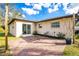 View of brick paved patio with exterior door to house at 1190 Victoria Ave Nw, Port Charlotte, FL 33948