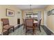 Bright dining room with wooden table and chairs, view to the pool at 138 Peckham Sw St, Port Charlotte, FL 33952