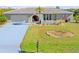 Single-story home with a large driveway and well-manicured lawn at 138 Peckham Sw St, Port Charlotte, FL 33952