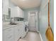 Laundry room with white cabinets, washer, dryer, and sink at 138 Peckham Sw St, Port Charlotte, FL 33952
