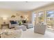Bright living room featuring a sectional sofa and large windows at 138 Peckham Sw St, Port Charlotte, FL 33952