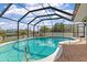 Enclosed kidney-shaped pool with canal views at 138 Peckham Sw St, Port Charlotte, FL 33952