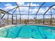 Relaxing pool with dolphin mosaic and screened enclosure at 138 Peckham Sw St, Port Charlotte, FL 33952