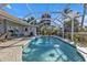 Relaxing screened-in pool with patio and water feature at 18061 Cullman Ave, Port Charlotte, FL 33948