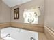 Spa-like bathroom with soaking tub and window at 18491 Hottelet Cir, Port Charlotte, FL 33948
