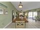 Casual dining area with wooden table and chairs near kitchen and living room at 18491 Hottelet Cir, Port Charlotte, FL 33948