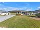 Ranch-style home with a well-manicured lawn at 18491 Hottelet Cir, Port Charlotte, FL 33948