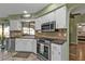 Kitchen features stainless steel appliances, white cabinets, and a breakfast bar at 18491 Hottelet Cir, Port Charlotte, FL 33948