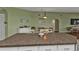 Kitchen island with granite countertop, white cabinets, and breakfast nook at 18491 Hottelet Cir, Port Charlotte, FL 33948