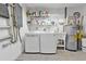 Bright laundry room with washer, dryer and shelving at 18491 Hottelet Cir, Port Charlotte, FL 33948