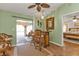 Bright living room, view of patio, wicker furniture, and hardwood floors at 18491 Hottelet Cir, Port Charlotte, FL 33948