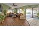Relaxing living room with brown leather sectional sofa and sliding doors leading to the pool at 18491 Hottelet Cir, Port Charlotte, FL 33948