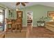 Open living area with hardwood floors, wicker furniture, and access to a patio at 18491 Hottelet Cir, Port Charlotte, FL 33948