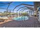 Screened pool with brick deck and canal views at 18491 Hottelet Cir, Port Charlotte, FL 33948