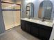 Double vanity bathroom with dark cabinets and a large walk-in shower at 2201 Grand Flora Trl, Bradenton, FL 34208