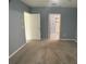 Primary bedroom with ensuite bathroom access and carpet flooring at 2201 Grand Flora Trl, Bradenton, FL 34208