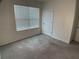Bright bedroom with large window and neutral carpeting at 2201 Grand Flora Trl, Bradenton, FL 34208