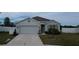 House exterior with two-car garage and landscaped yard at 2201 Grand Flora Trl, Bradenton, FL 34208