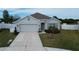 House exterior with two-car garage and landscaped yard at 2201 Grand Flora Trl, Bradenton, FL 34208