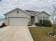 House exterior featuring a two-car garage and well-maintained lawn at 2201 Grand Flora Trl, Bradenton, FL 34208