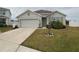 One-story house with a two-car garage and landscaped front yard at 2201 Grand Flora Trl, Bradenton, FL 34208