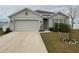 Curb appeal abounds at this charming one-story home, featuring a well-manicured lawn and tasteful landscaping at 2201 Grand Flora Trl, Bradenton, FL 34208