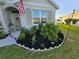 Neatly landscaped front yard with flowering plants and mulch at 2201 Grand Flora Trl, Bradenton, FL 34208