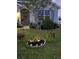 Landscaped front yard with a variety of plants and flowers at night at 2201 Grand Flora Trl, Bradenton, FL 34208