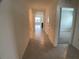 Bright and spacious hallway with tile flooring, leading to other rooms in the house at 2201 Grand Flora Trl, Bradenton, FL 34208