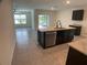 Modern kitchen with dark cabinetry, stainless steel appliances, and an island at 2201 Grand Flora Trl, Bradenton, FL 34208