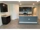 Modern kitchen featuring dark cabinets, granite countertops, and an island at 2201 Grand Flora Trl, Bradenton, FL 34208