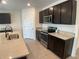 Spacious kitchen with dark wood cabinets, stainless steel appliances, and granite countertops at 2201 Grand Flora Trl, Bradenton, FL 34208