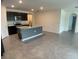 Modern kitchen features island, stainless steel appliances, and dark cabinetry at 2201 Grand Flora Trl, Bradenton, FL 34208