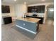 Modern kitchen with dark cabinets, granite counters, and an island at 2201 Grand Flora Trl, Bradenton, FL 34208