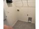 Small laundry room with hookups and shelving at 2201 Grand Flora Trl, Bradenton, FL 34208