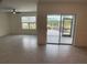Living room with sliding glass doors to patio at 2201 Grand Flora Trl, Bradenton, FL 34208