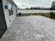 Grey paver patio with surrounding lawn at 2201 Grand Flora Trl, Bradenton, FL 34208