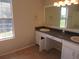 Bathroom with double vanity, a large mirror, and ample counter space, providing a functional and stylish space at 2410 Lanier Rd, Punta Gorda, FL 33982