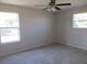 This is a bedroom featuring two windows that provide natural light and a ceiling fan at 2410 Lanier Rd, Punta Gorda, FL 33982