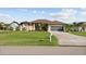 One story house with a brown tile roof and a large lawn at 25386 Saint Helena Ln, Punta Gorda, FL 33983