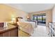 Cozy bedroom with a full-size bed and access to patio at 3256 White Ibis Ct # 22A, Punta Gorda, FL 33950