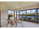 Enclosed patio overlooking canal, featuring glass doors and ceiling fan at 3256 White Ibis Ct # 22A, Punta Gorda, FL 33950