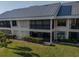 Condo building with metal roof and lush landscaping at 3256 White Ibis Ct # 22A, Punta Gorda, FL 33950