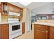 Kitchen with wood cabinets and white appliances at 3256 White Ibis Ct # 22A, Punta Gorda, FL 33950