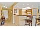 Kitchen features a breakfast bar and view into living area at 3256 White Ibis Ct # 22A, Punta Gorda, FL 33950
