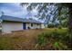 Ranch style home with a spacious backyard and blue door at 4485 Herder St, Port Charlotte, FL 33948