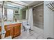 Clean bathroom with a bathtub, toilet and wooden vanity at 4485 Herder St, Port Charlotte, FL 33948