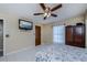 Bedroom with tiled floor, ceiling fan, and flat screen TV at 4485 Herder St, Port Charlotte, FL 33948