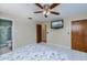 Bedroom with tiled floor, ceiling fan and flat screen TV at 4485 Herder St, Port Charlotte, FL 33948